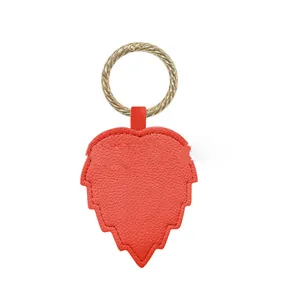 High-quality red leaf-shaped leather hat clip with a golden textured ring storage accessory