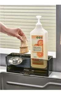 Transparent grey sink storage rack holding kitchen cleaning tools and soap bottle.
