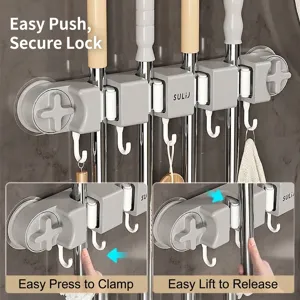 Suction cup mop holder with non-slip rollers and hooks for kitchen wall storage