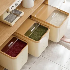 Minimalist cream-colored grain storage containers with transparent lids on a wooden shelf