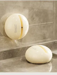 Close-up of a cream-colored suction cup knife sharpener with a tungsten steel slot.