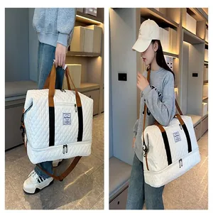 Large capacity quilted travel duffel bag showing crossbody and handheld styling details.