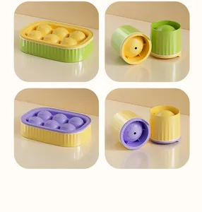 Detailed view of 6-cell and single-cell ice ball molds in yellow, green, and purple.