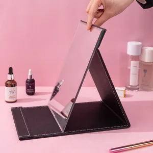 Foldable desktop makeup mirror with adjustable angle and premium black leather cover
