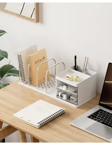 Detailed view of a white minimalist desk organizer featuring book racks and small drawers.