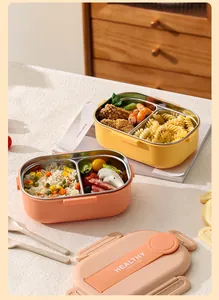 Détail d'une boîte à lunch en acier inoxydable 304 avec nourriture et couvercle pêche.
