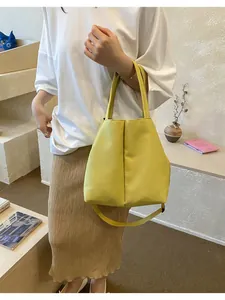 Stylish model carrying a vibrant yellow large capacity water bottle crossbody tote bag