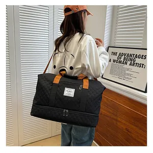 Large capacity fitness travel duffel bag with bottom compartment, stylish quilted black design.