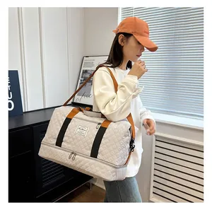 Large capacity quilted travel duffel bag with shoulder strap, ideal for fitness and short trips.