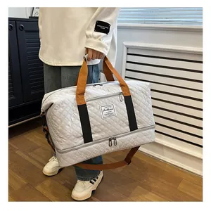 Large capacity quilted travel duffel bag with shoulder strap, ideal for fitness and short trips.