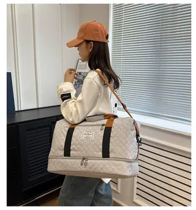 Large capacity travel duffel bag with quilted design, shoulder strap and bottom compartment.