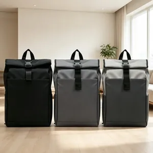 Three minimalist roll-top backpacks in black and gray displayed in a modern interior setting.