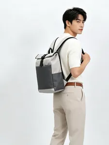 Detailed view of the modern color-block leisure backpack on an Asian male model.