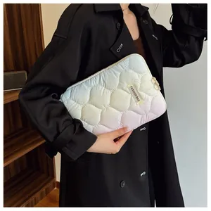 Gros plan d'une pochette d'ordinateur portable matelassée avec dégradé de couleurs pastel.