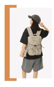 Stylish Korean-style plaid nylon backpack for women shown in a casual outdoor setting