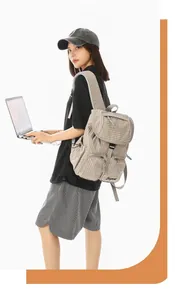 Detailed side view of the lightweight grey checkered nylon backpack on a casual model