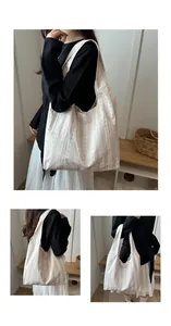 Detailed views showing a beige striped tote bag with bow patterns on a shoulder