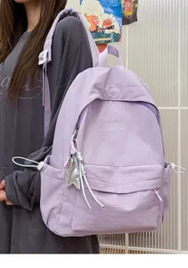 Vista dettagliata di uno zaino in nylon viola minimalista con ciondolo a stella.