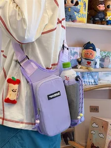 Functional purple crossbody sports bag with integrated water bottle holder and apple charm