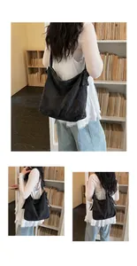 Stylish black denim hobo bag worn by a model against a library backdrop for scale