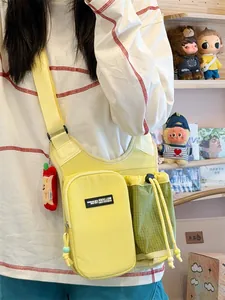 Yellow and green outdoor sports crossbody bag with water bottle holder shown on model