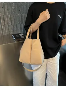 Elegant beige crossbody commuter bag designed for daily essentials and large water bottles