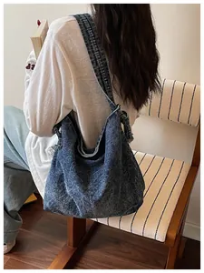 Vintage washed denim crossbody hobo bag shown on model for daily casual style