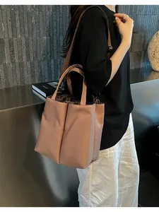 Commuter handbag with double cup compartments shown in a stylish dusty pink finish