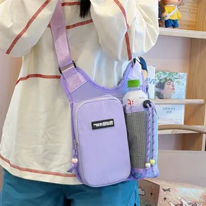 Detail view of a purple outdoor crossbody bag featuring a dedicated water bottle holder