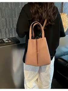 Detail of a modern pink fabric tote bag for water bottles and cups carried by a model