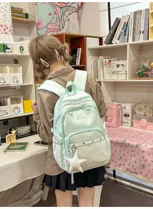 Mint green academy style schoolbag with polka dots, stripes, and a cute star pendant.