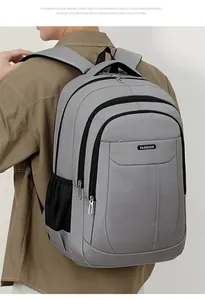 Back view detail of a large capacity grey business commute backpack on a male model