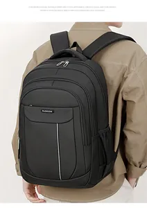 Detailed view of black business backpack with multiple compartments worn by a model