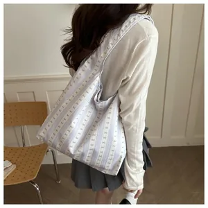 Shoulder bag for women featuring a gentle lavender striped pattern and small bows