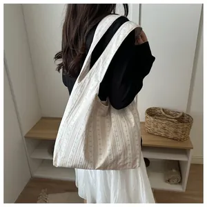 Casual striped tote bag with bow pattern shown on model's shoulder for daily use