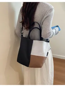 Detail showing a model wearing a tri-color block shoulder bag for everyday use.