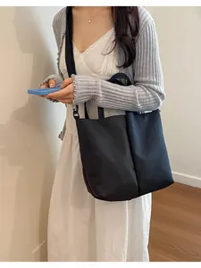 Large capacity dual cup carrier bag worn by model for daily commute