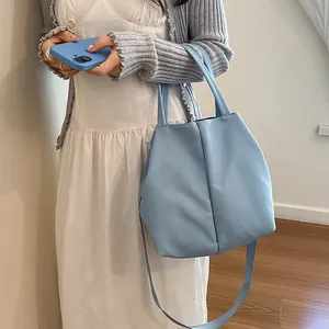 Stylish large light blue crossbody tote bag designed for water bottles and daily commuting essentials