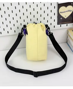 Back view of a lightweight pale yellow drawstring water bottle bag with black strap