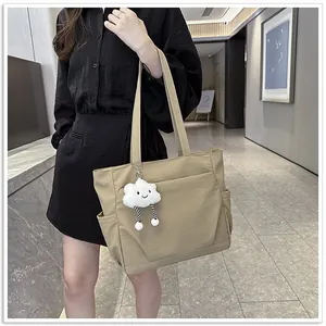 Stylish khaki large capacity tote bag worn by model in modern indoor setting