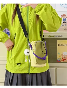 Detailed view of lightweight crossbody water cup bag worn with lime green jacket
