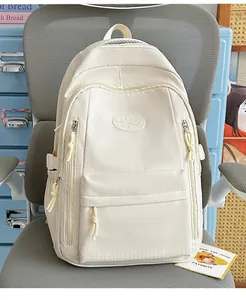 Close-up of a cream minimalist student backpack featuring subtle grid texture details