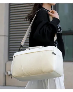 Model carrying a large white multi-functional travel duffel bag for fitness and sport