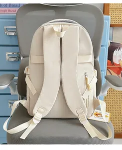 Detailed back view of beige minimalist backpack with padded straps and zipper pocket