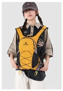 Detail of yellow outdoor sports hydration backpack worn by model for hiking and cycling