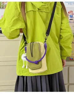 Outdoor dopamine-style lightweight crossbody phone bag worn over a neon green jacket