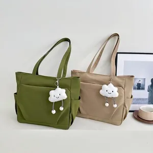 Minimalist large capacity nylon commuter tote bag for women with a cute plush cloud charm.
