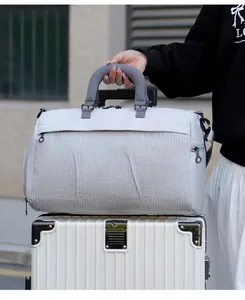 Large travel duffel bag with trolley sleeve mounted on a white luggage suitcase