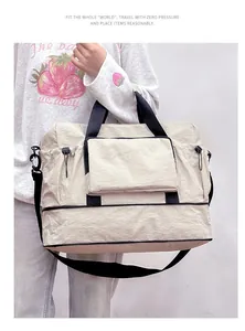Detailed view of a large capacity beige travel bag with black handles and shoulder strap