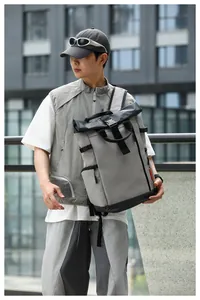 Grey waterproof Oxford backpack for men in an urban outdoor lifestyle setting